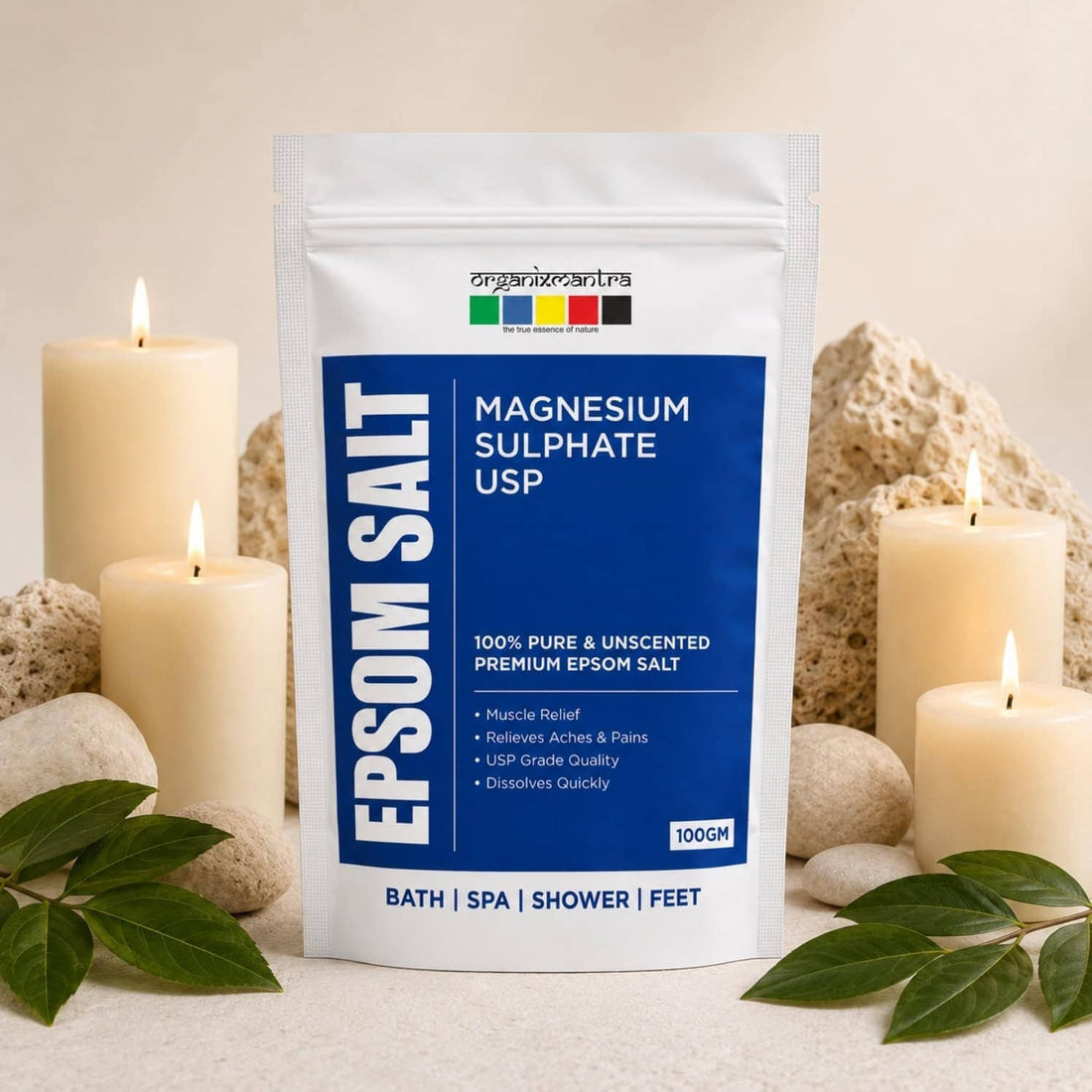 Organix Mantra Epsom Salt 100 g pouch, magnesium sulphate USP, styled with lit candles, pumice stones and green leaves