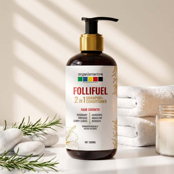 Follifuel 2-in-1 Shampoo and Conditioner 300 ml pump bottle beside fresh rosemary, white pebbles and folded towels