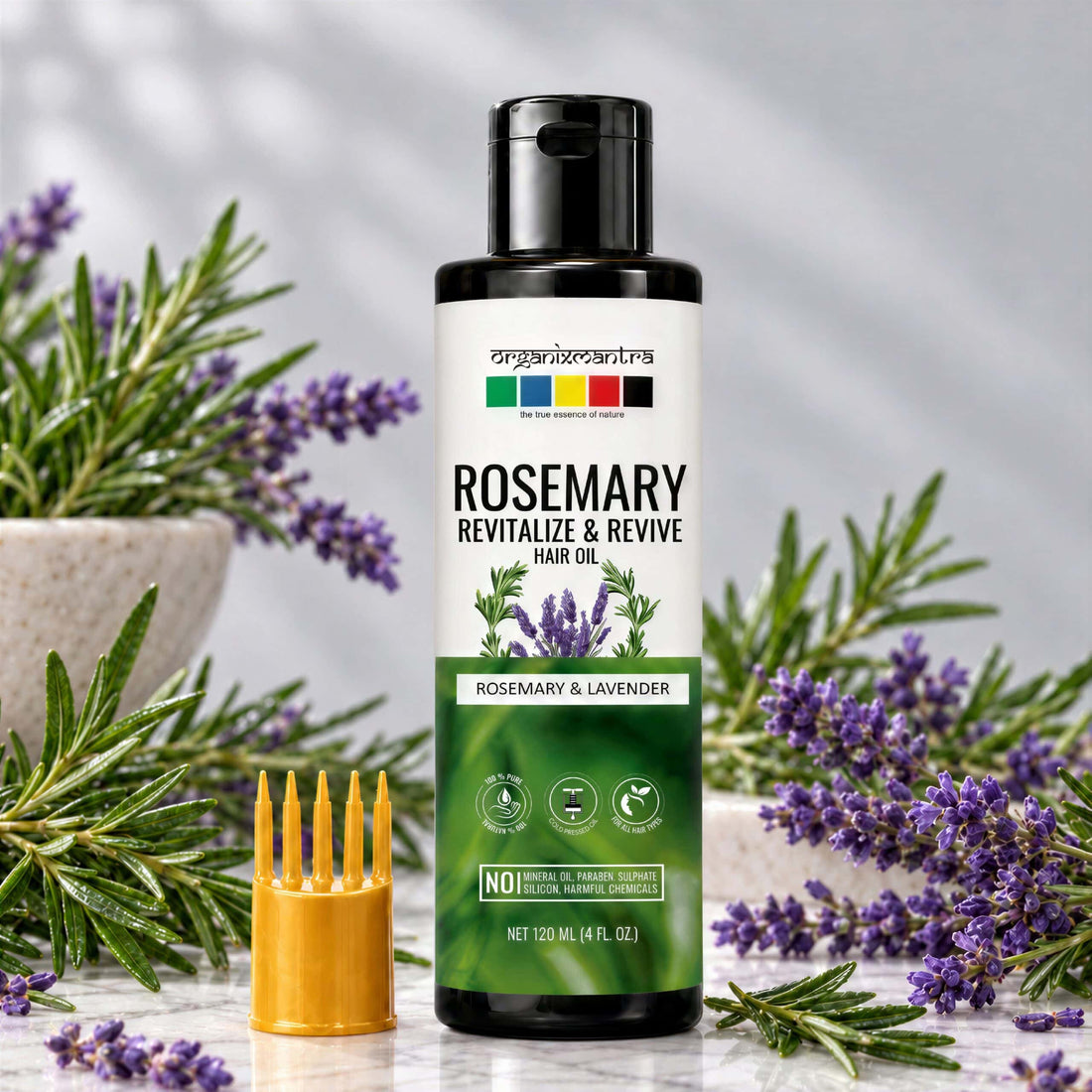 Organix Mantra Rosemary & Lavender Hair Oil 120 ml bottle with its comb applicator cap, fresh rosemary and lavender sprigs